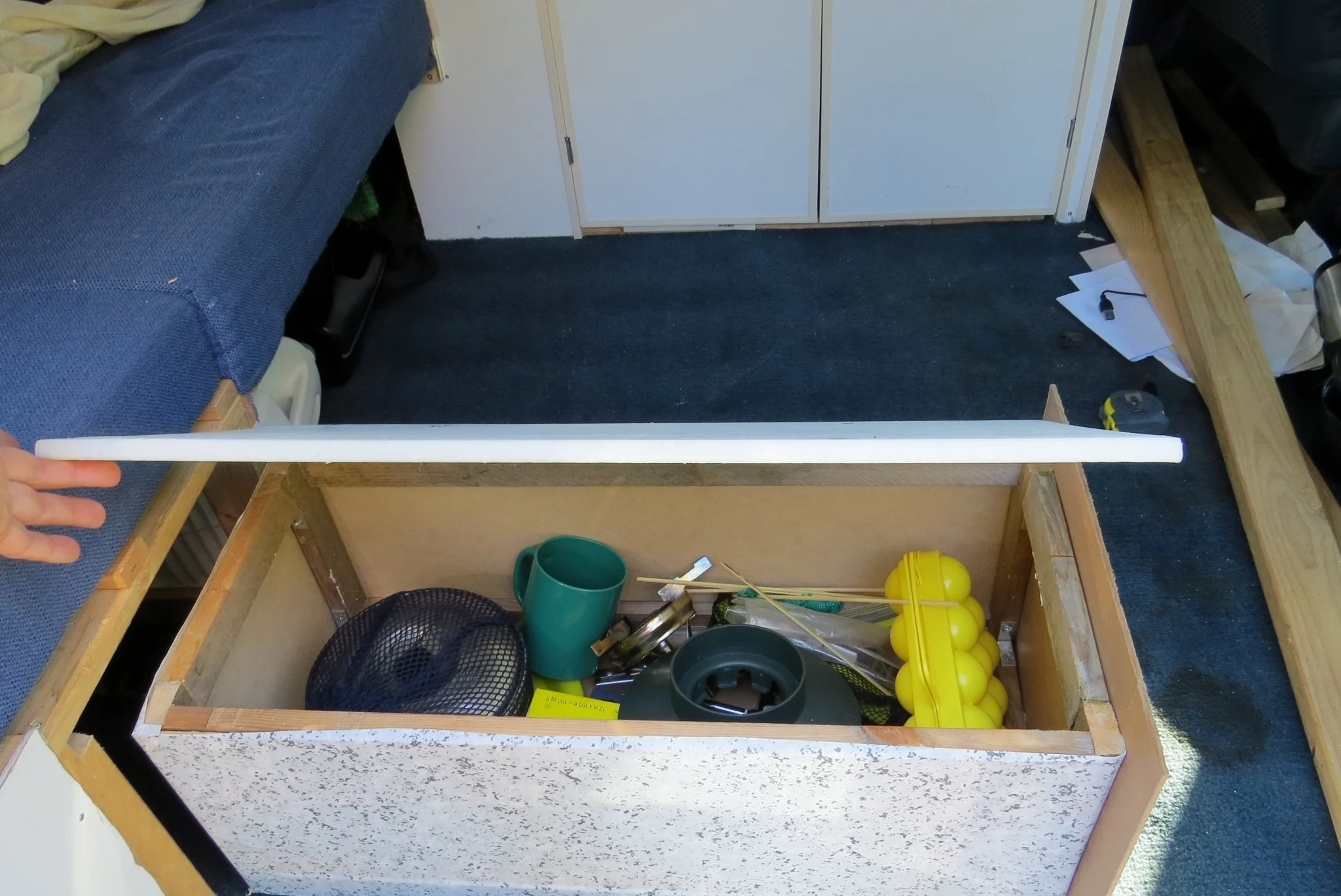 Astro van conversion under seat storage open