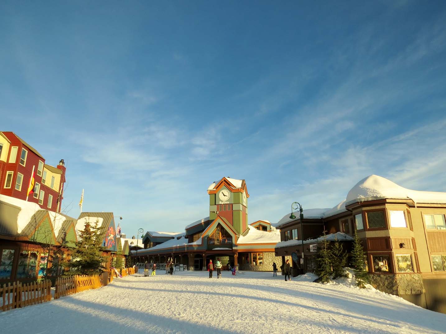 bright coloured buildings with snowy paths at Big White Ski Resort