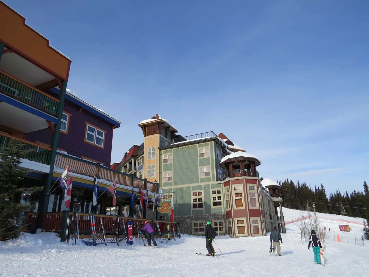 skiers and ski racks next to Silver Star village buildings