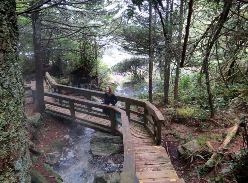 Gemma on boardwalk bridge in forest leading to Hot Springs Cove, Tofino