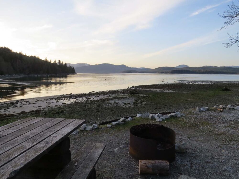 Picnic table, fire pit and ocean views from free recreational site in Canada