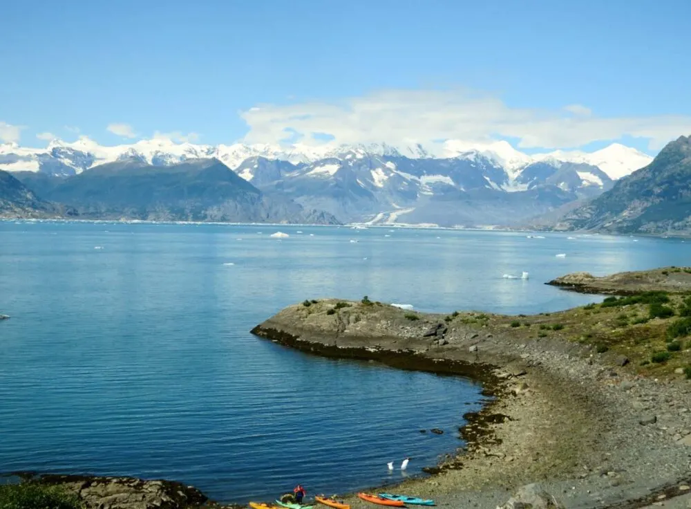 Looking down at a peninsula of rock in front of Columbia Bay mountains