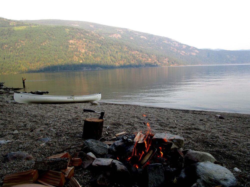 campfire and canoe next to christina lake 