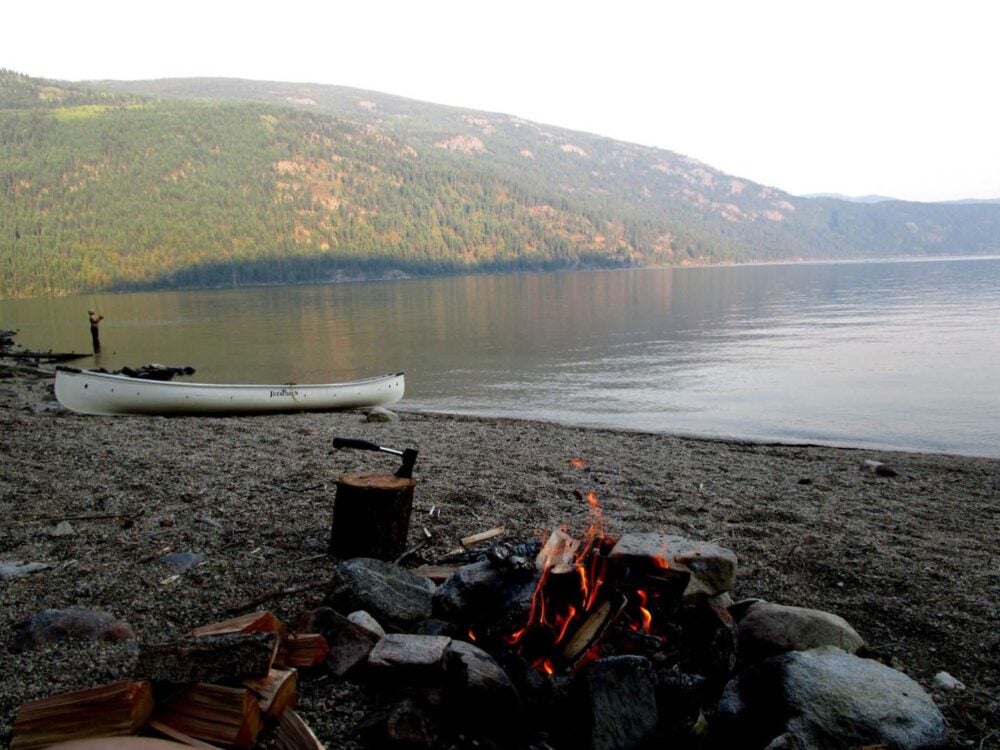 campfire and canoe next to christina lake 