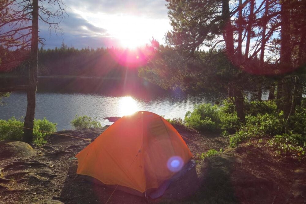 Orange tent by the side of Mohun Lake, Vancouver Island