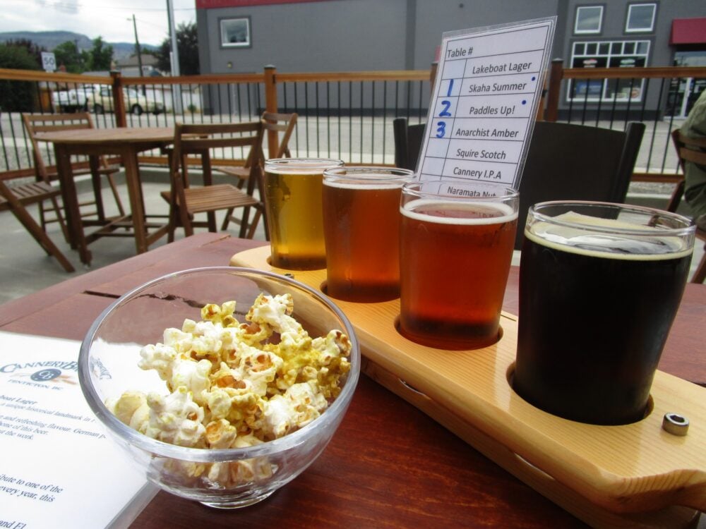 A flight of tour taster beers on a patio in Penticton