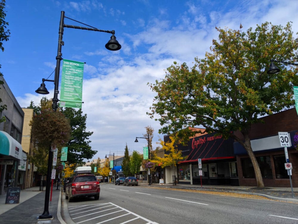 Downtown Penticton with shops, street lights and parked cars