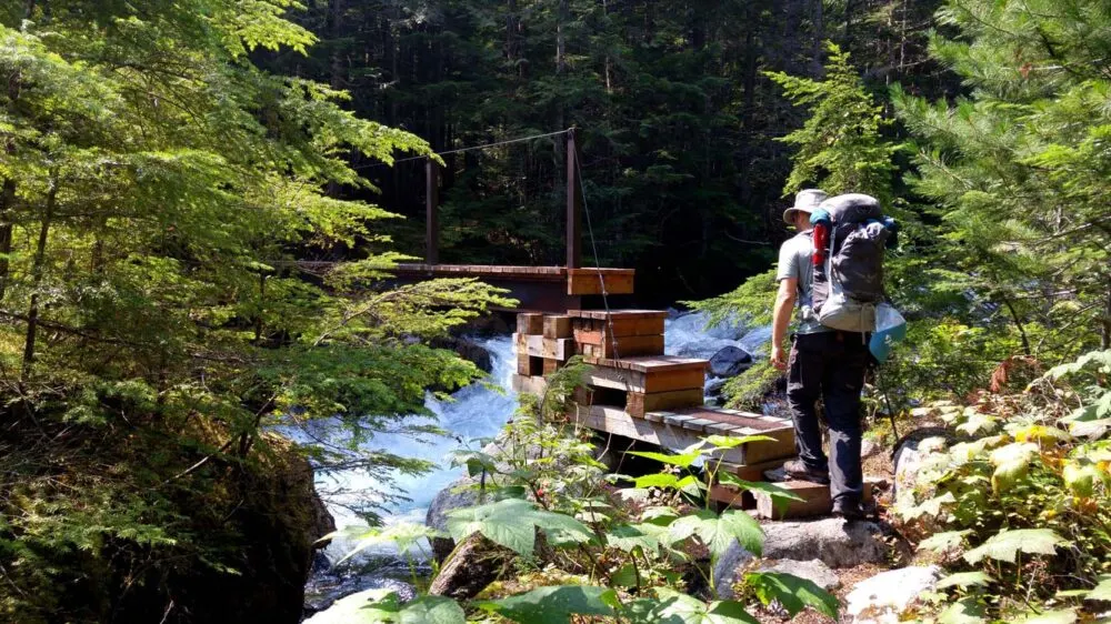 Crossing a bridge while hiking in Valhalla Provincial Park, near Nelson