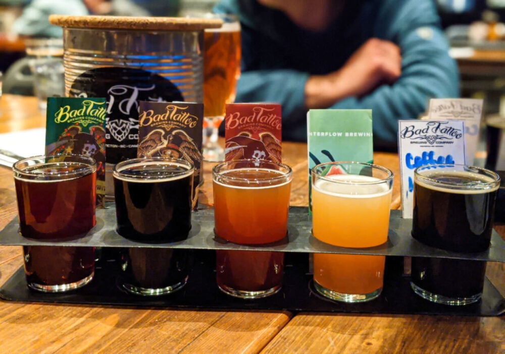 Close up of beer flight at Bad Tattoo, with five differently coloured beers in holder