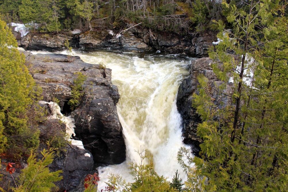 Looking across to large, rushing waterfall plunging into canyon