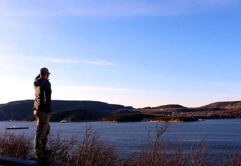 Back view of JR whale watching from shore in Tadoussac from the Pointe Noire pullout. He is looking across the river for any signs of beluga whales