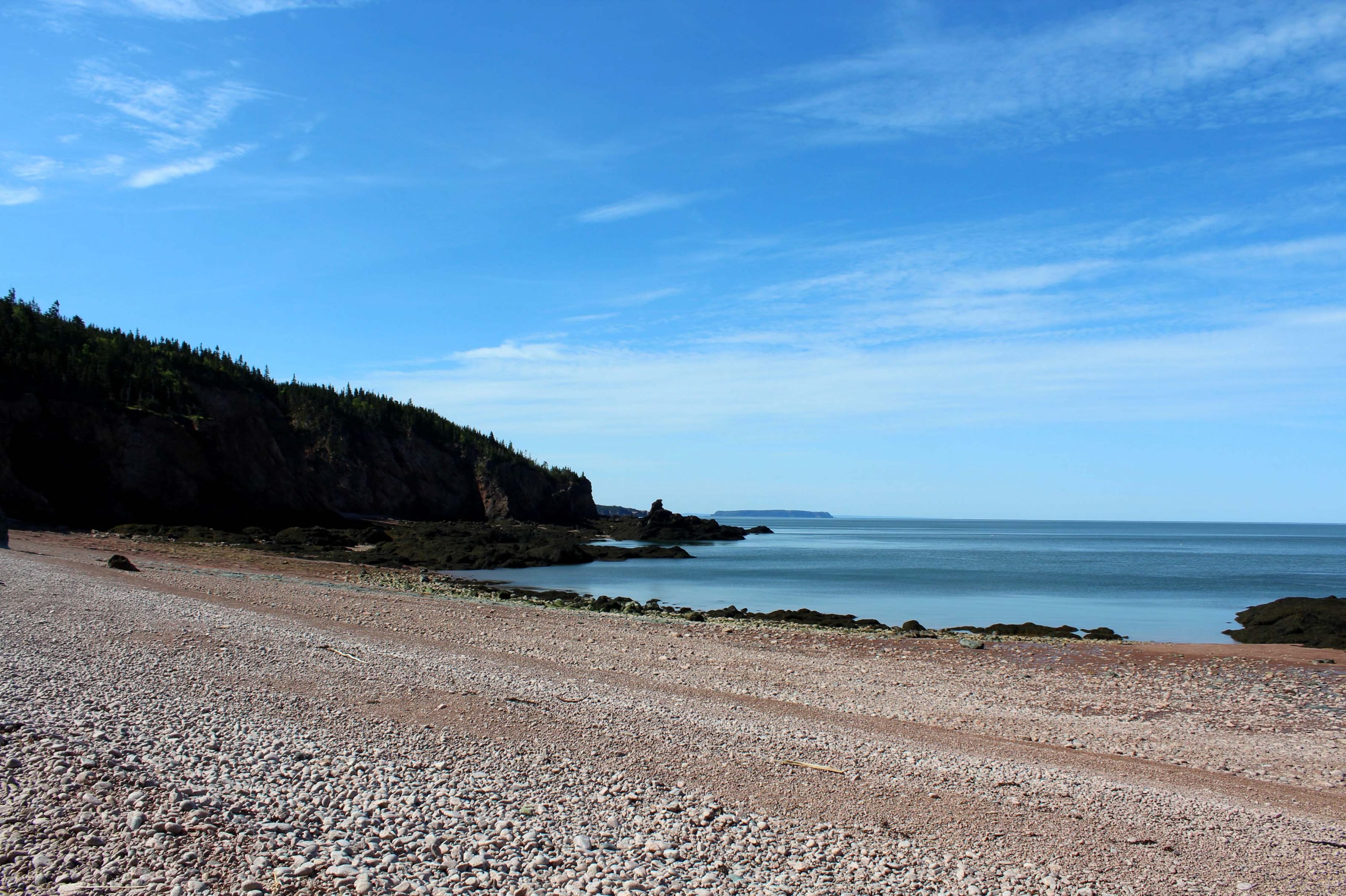 Rocky, slightly pink tinged beach at Seal Cove