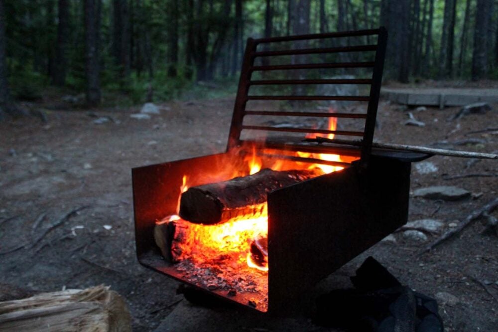 Close up of firebox with active fire at campsite in Kejimkujik National Park