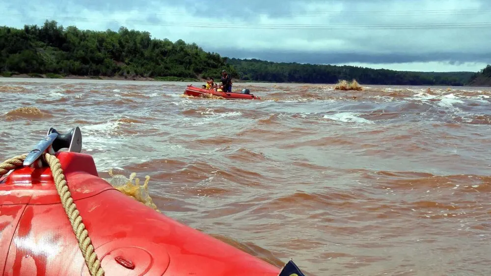 View from red raft looking at standing waves with other rafts tackling the rough water