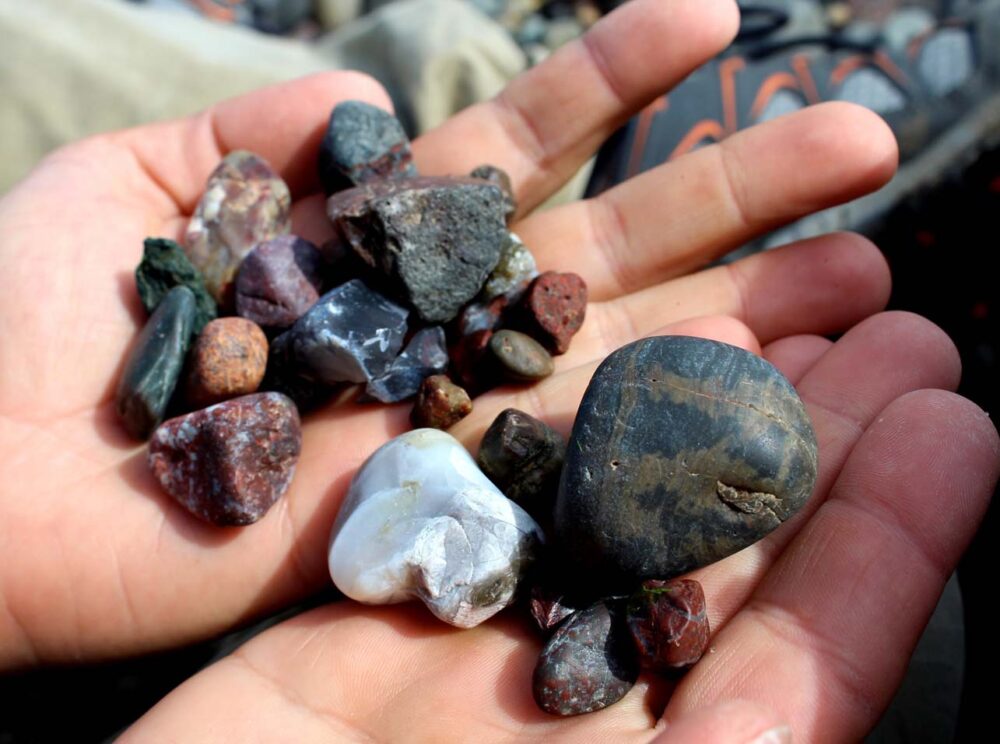 Handfuls of colourful rocks and agates in Pond Cove