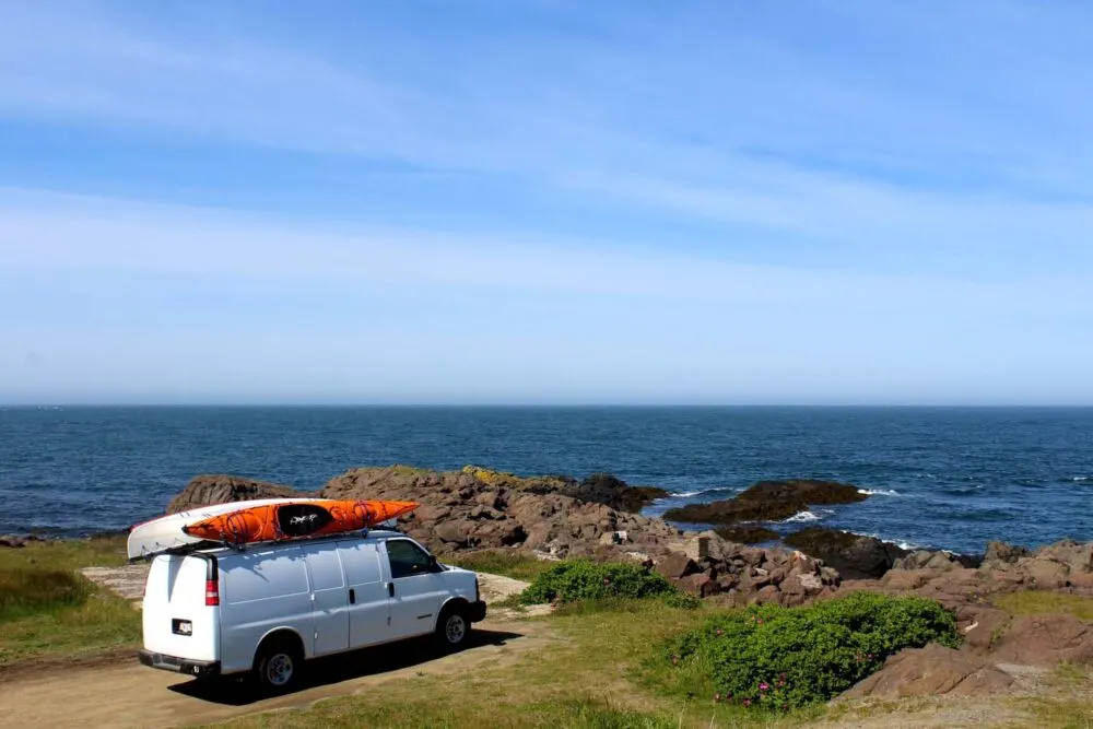 White van on rocky coastline, Nova Scotia