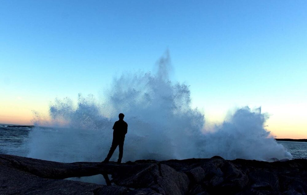 JR with big ocean waves at louisbourg lighthouse, nova scotia