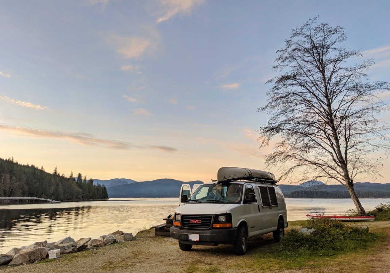 White van parked by ocean at campsite on Vancouver Island coast