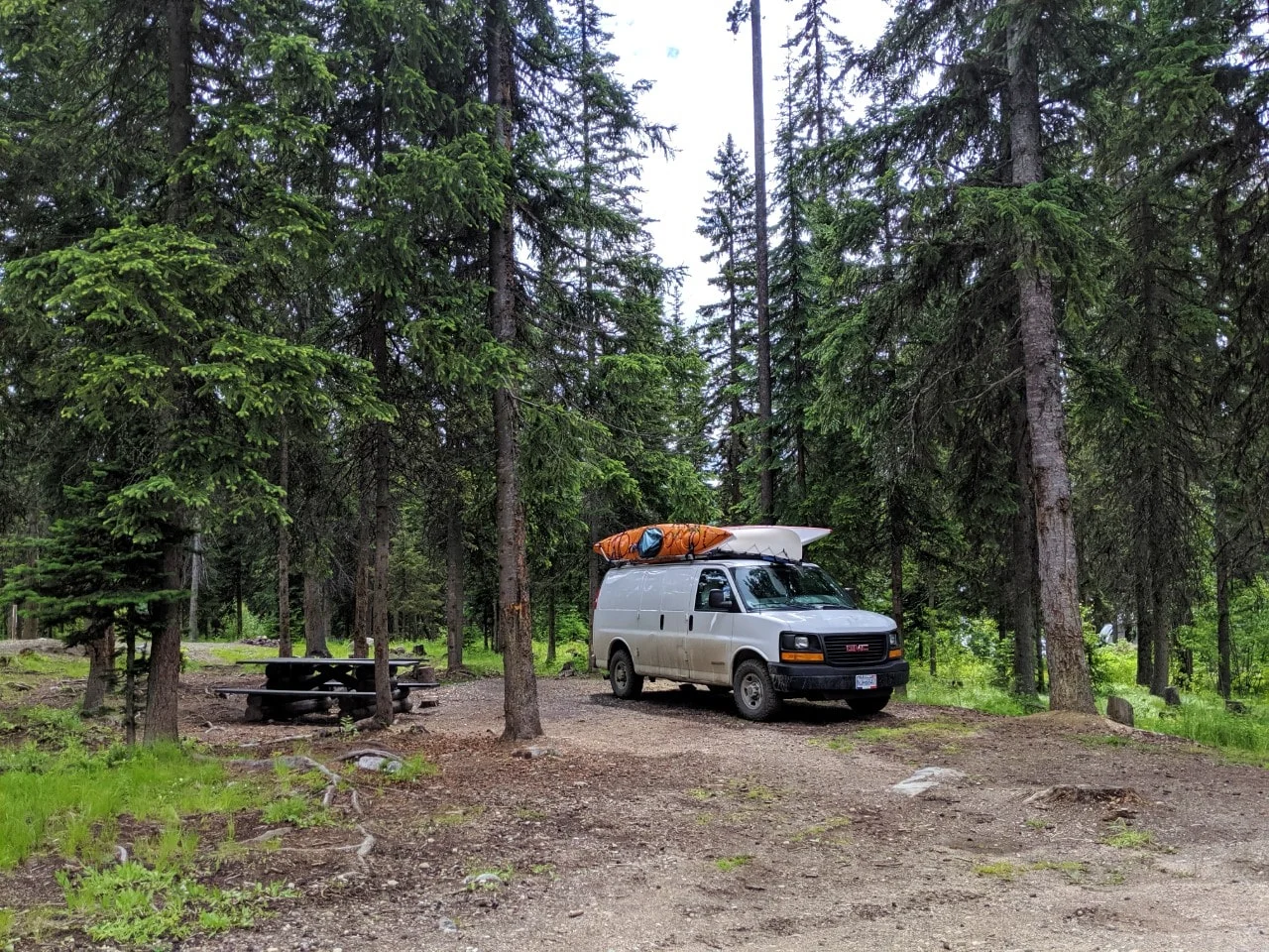 White van parked next to picnic table at free camping site in British Columbia