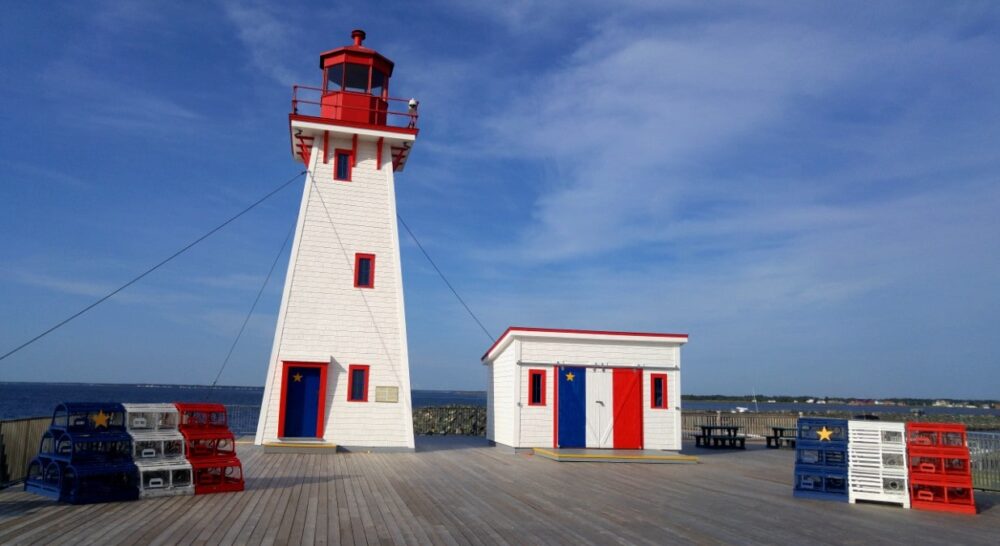 Shippagan lighthouse with Acadian flags