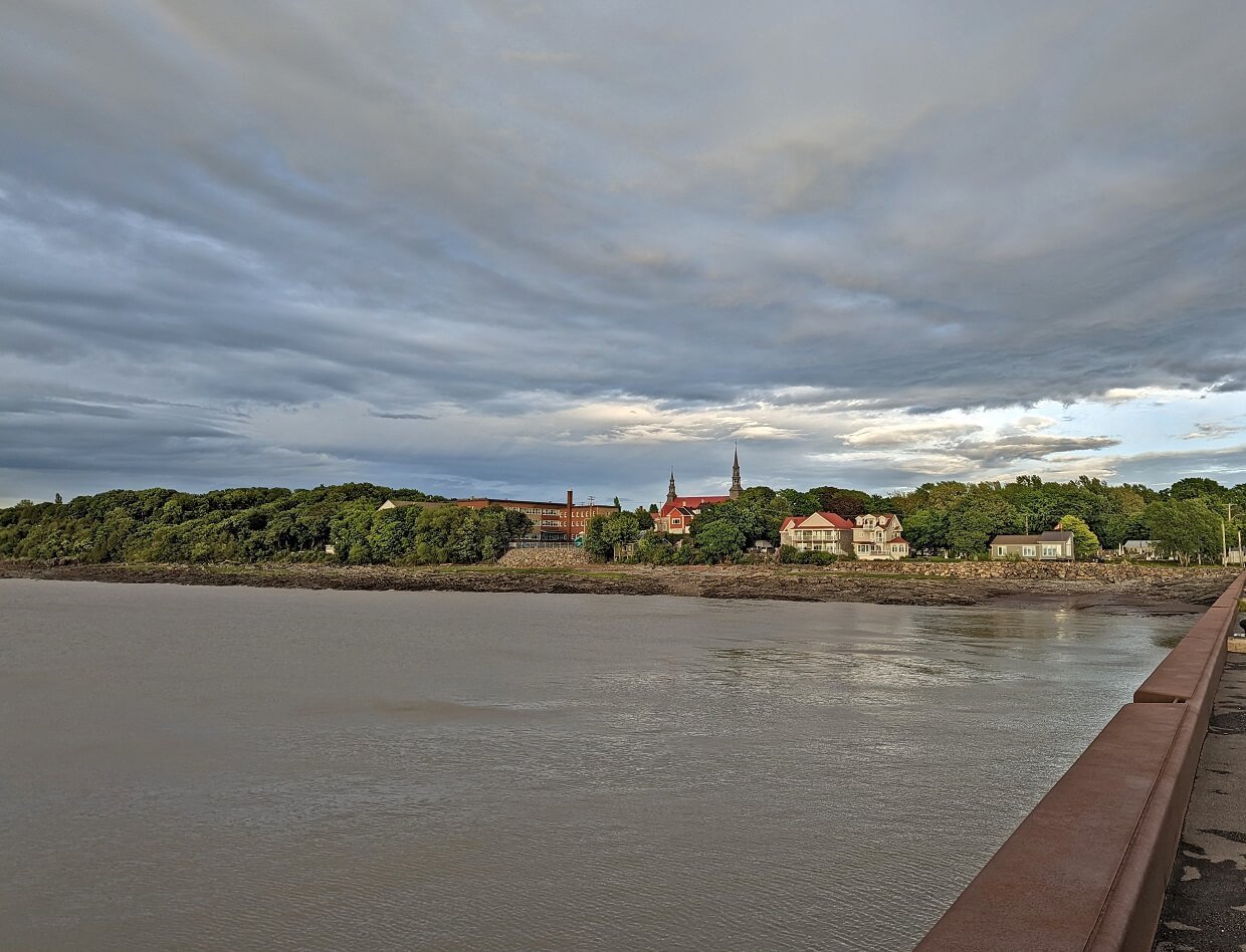 Pier view of Saint Jean Port Joli town, with church spires visible as well as some historic buildings