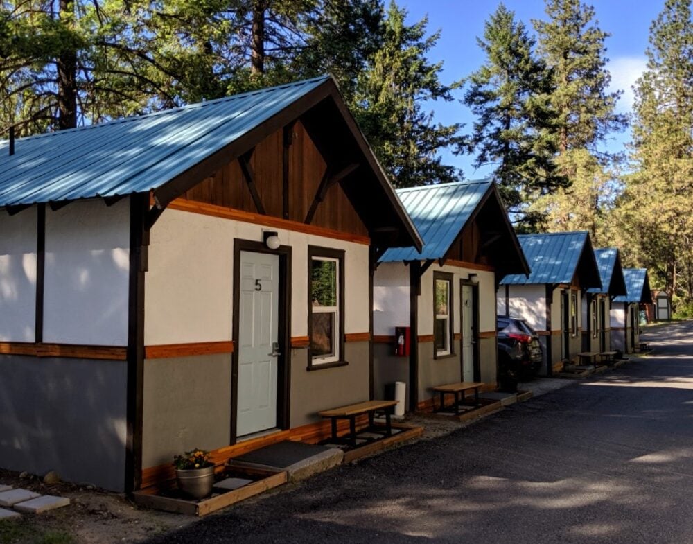 Side view of five LOGE cabins, next to the river in Leavenworth