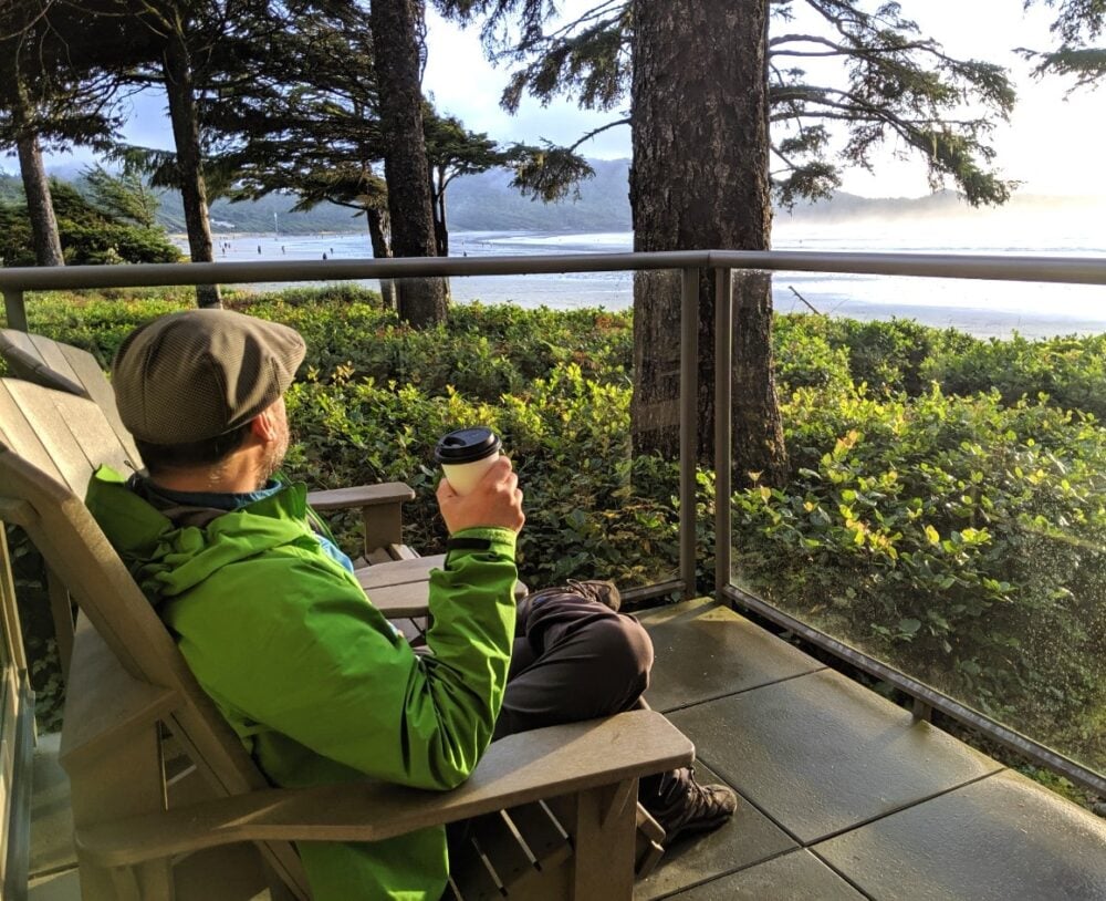 JR sitting on deck chair on balcony watching the ocean