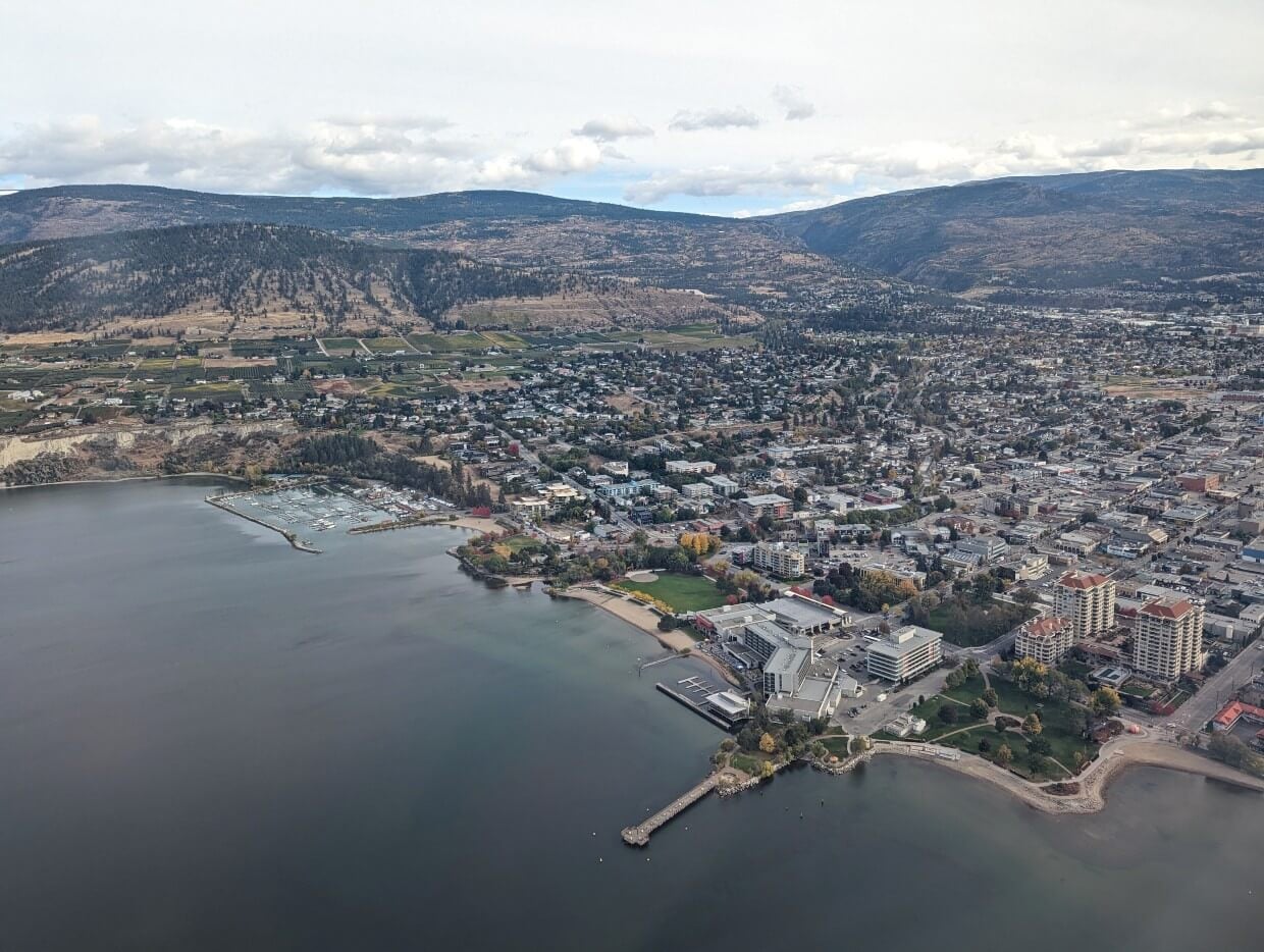 Plane view of the city of Penticton next to Okanagan Lake with pier stretching onto water