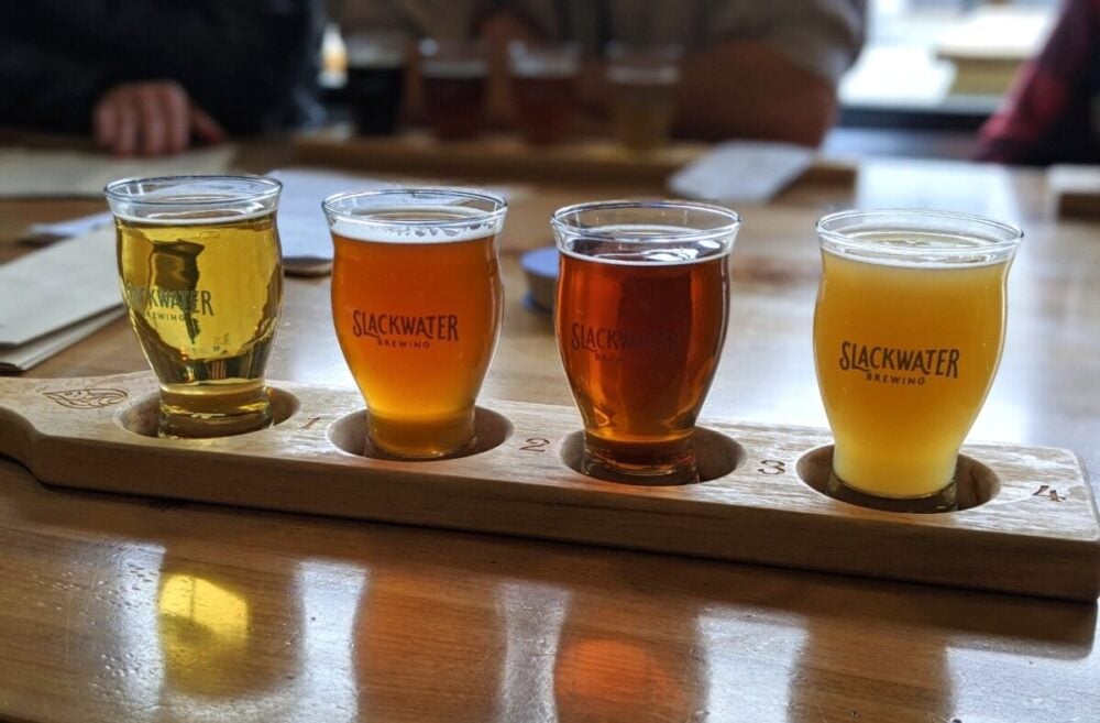 Four beers on wooden tasting flight at Slackwater Brewing