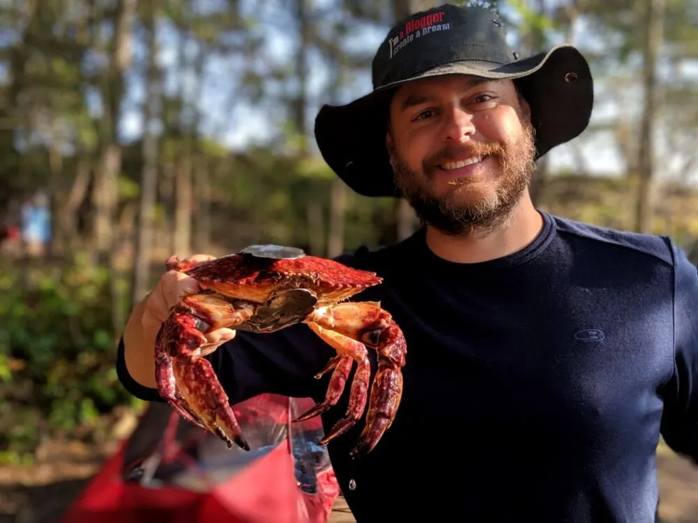 JR holding up a red rock crab to the camera