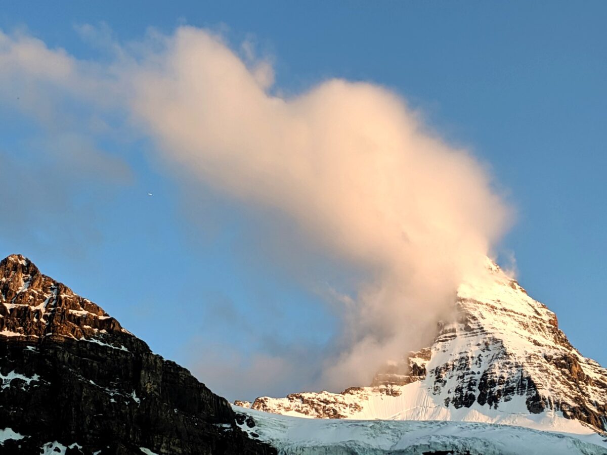 The summit of Mount Assiniboine with cloud over summit