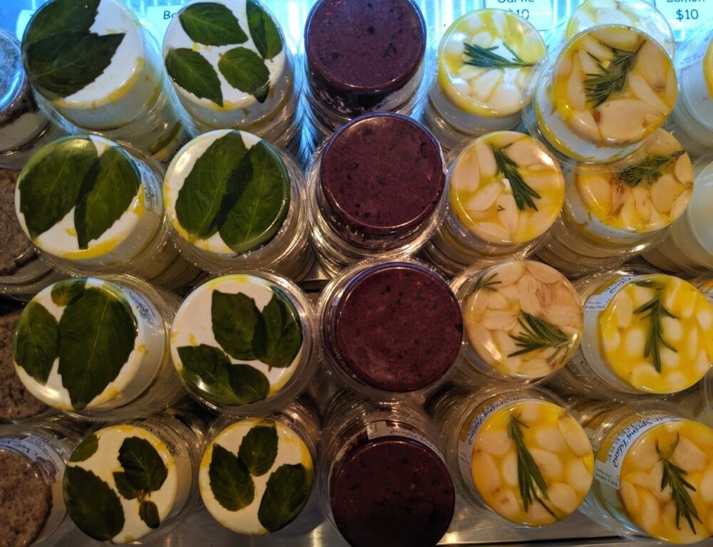 Overhead view of round plastic covered goats cheeses at Salt Spring Island Cheese