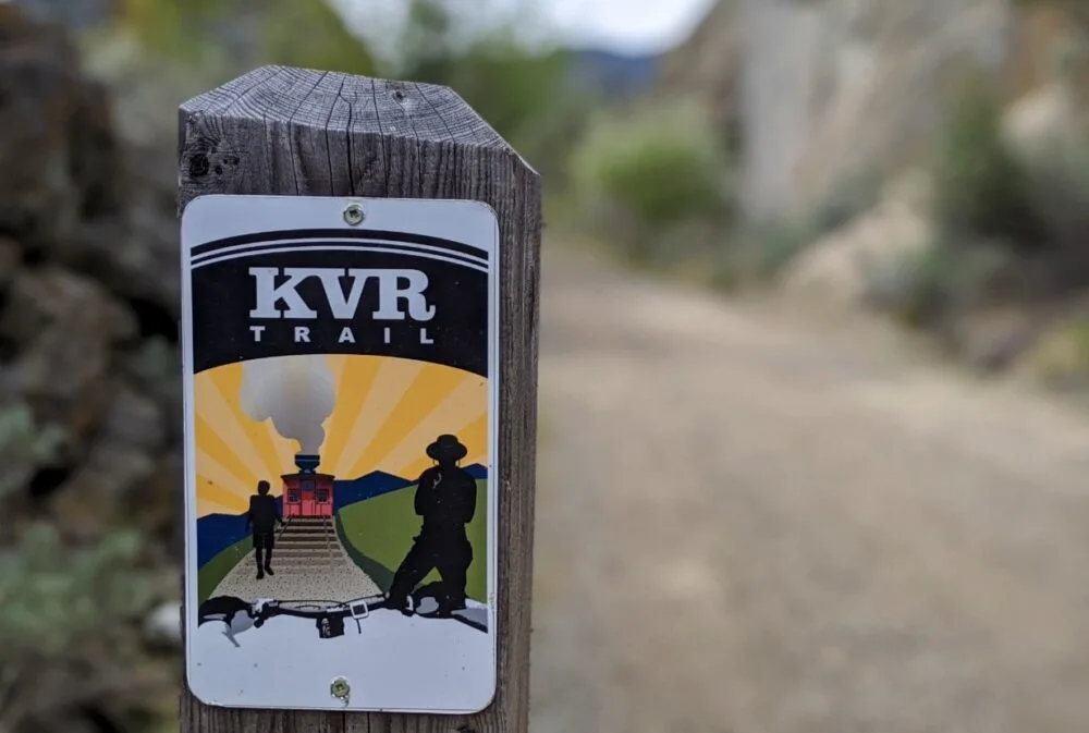 KVR trail on wooden post with view of trail behind