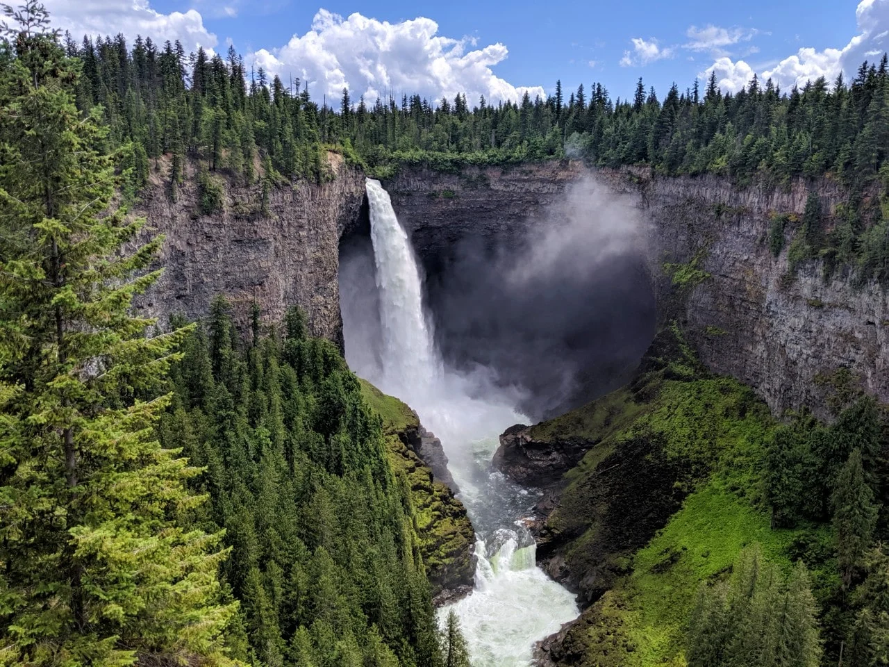 141m Helmckcen Falls plunging into a lush canyon in Wells Gray Provincial Park. The canyon is surrounded by forest