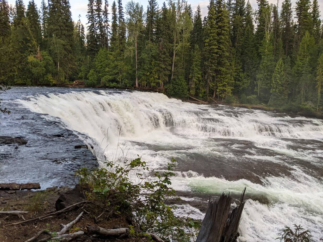 Looking across wide horseshoe shaped cascading waterfall in Wells Gray
