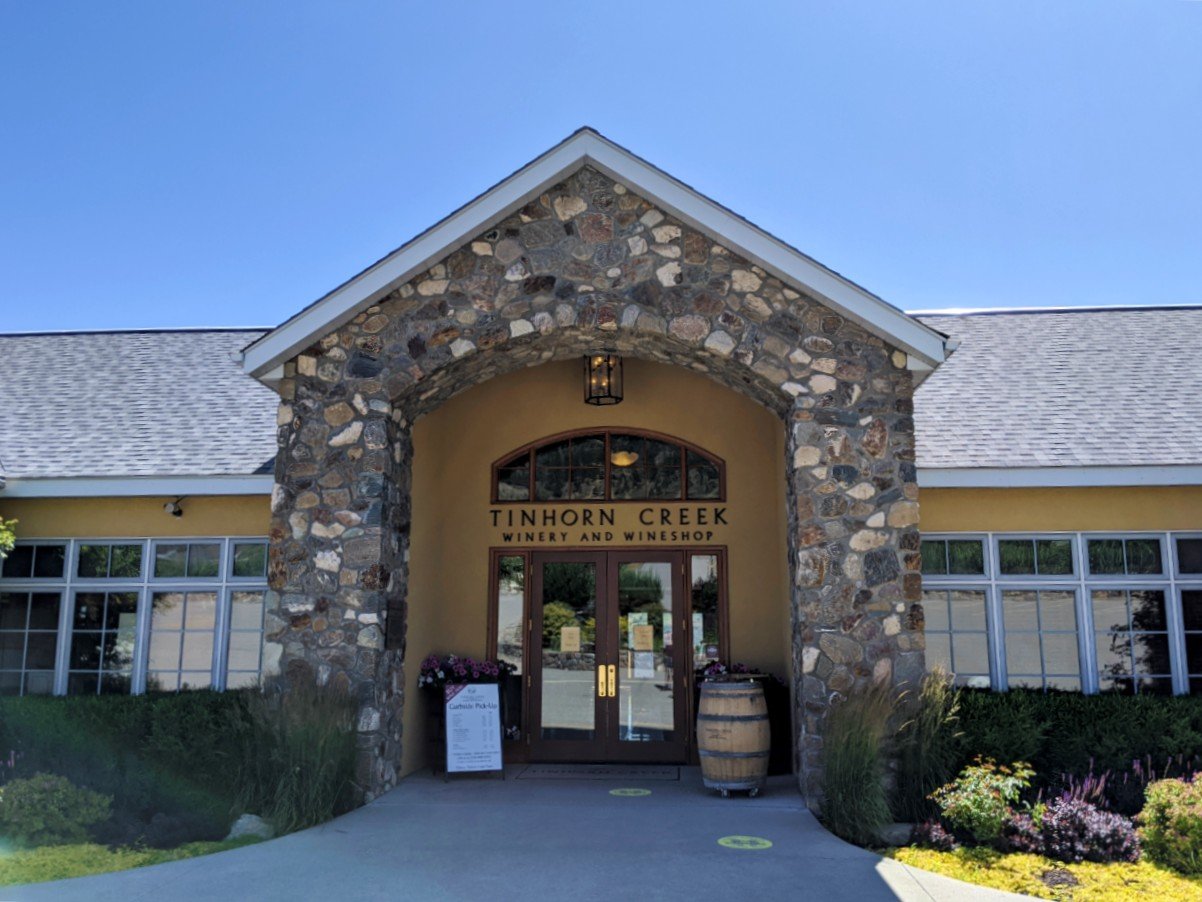 Tinhorn Creek Winery entrance with stone arch and wine barrel