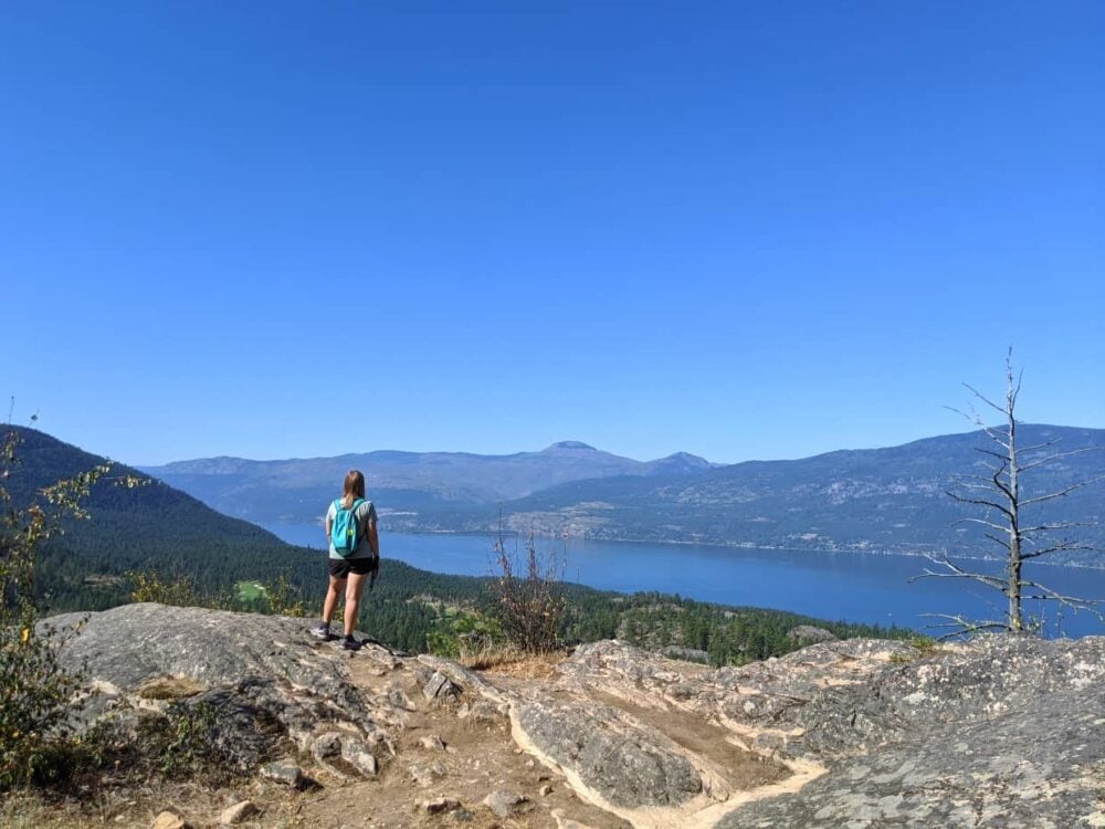 Gemma standing on top of rock at Okanagan Lake lookout, Predator Ridge