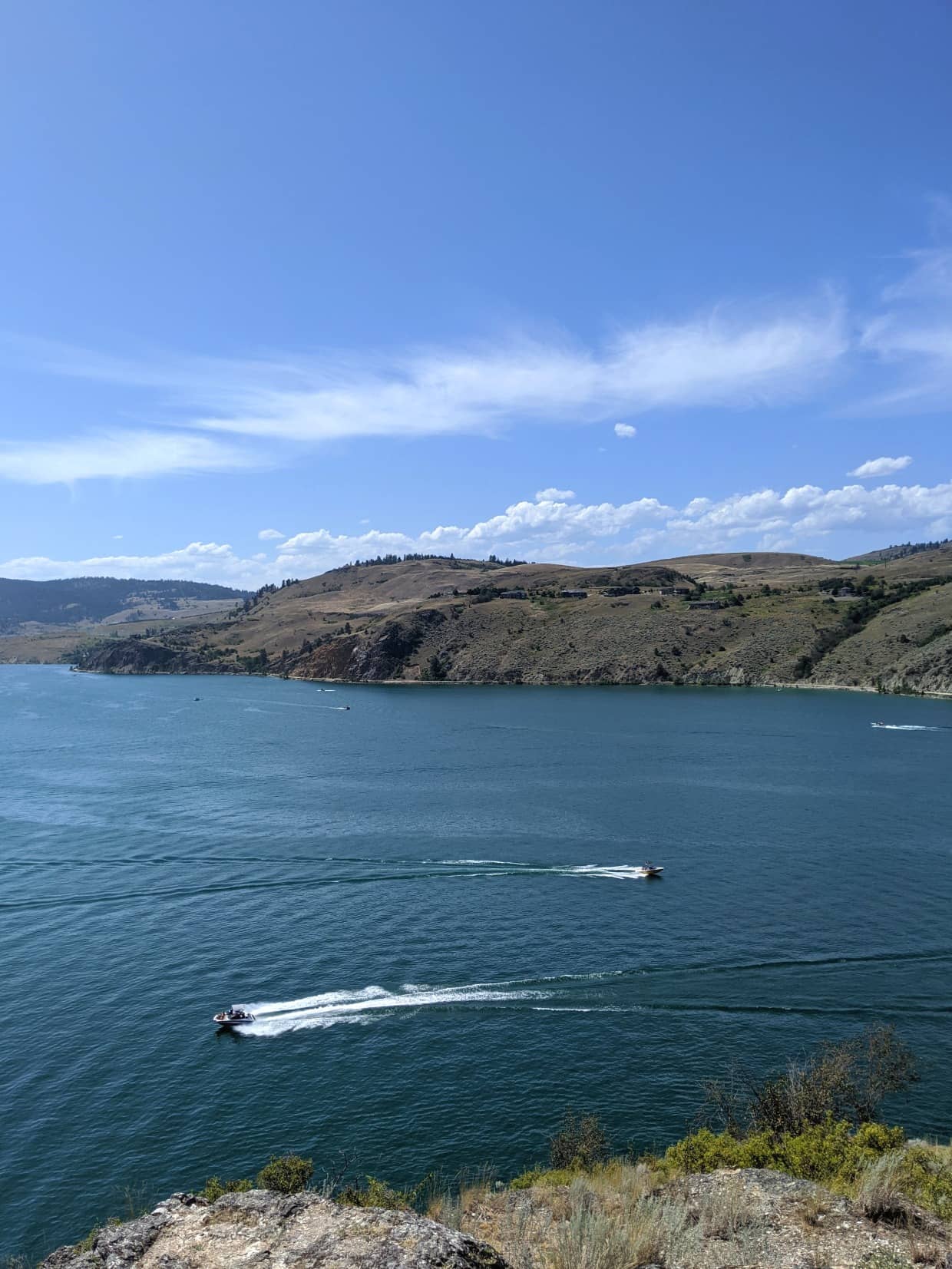 Lookout view of Kalamalka Lake with powerboats passing