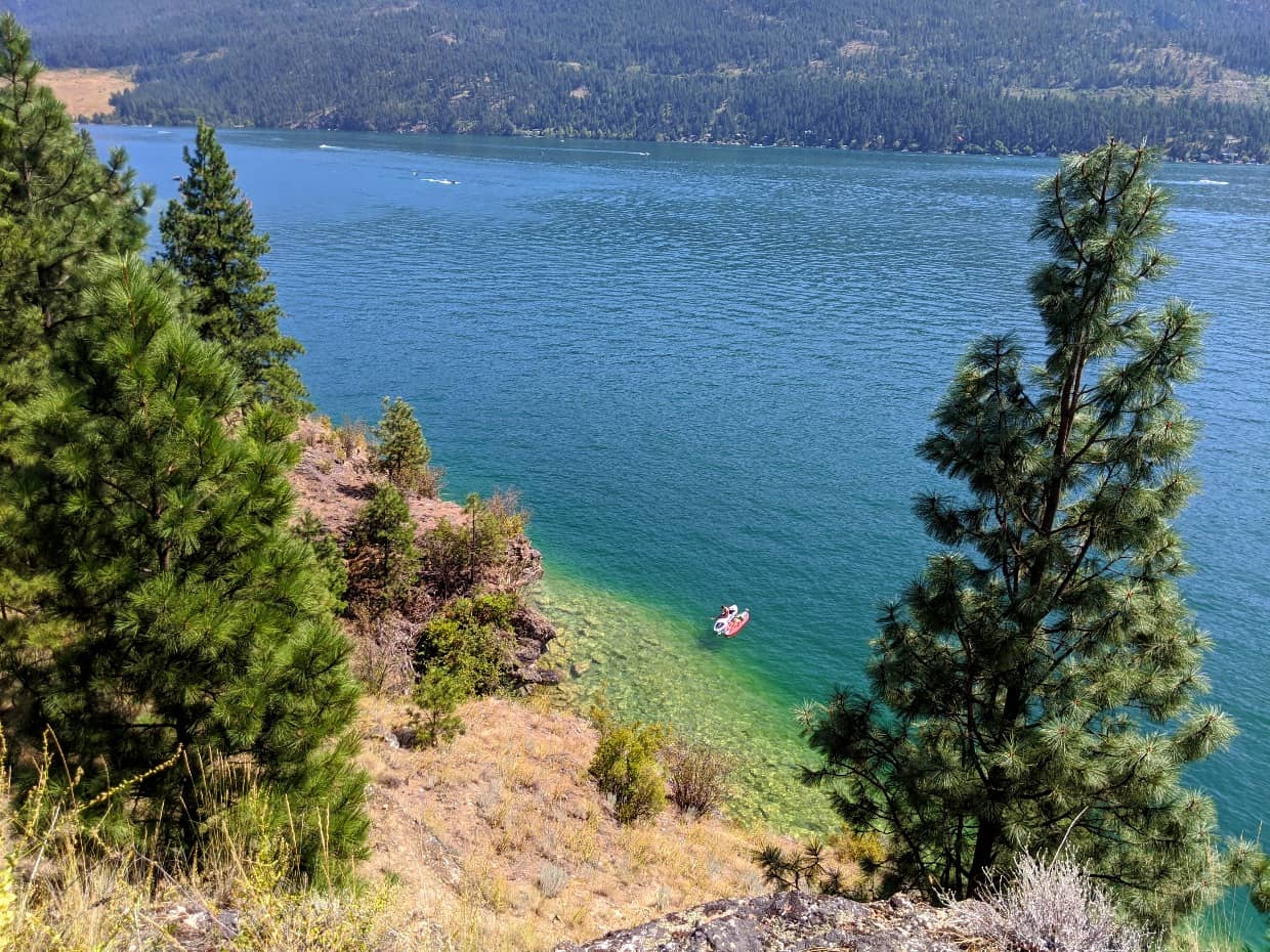 Looking down on paddleboards on Kalamalka Lake, with bright blue lake water