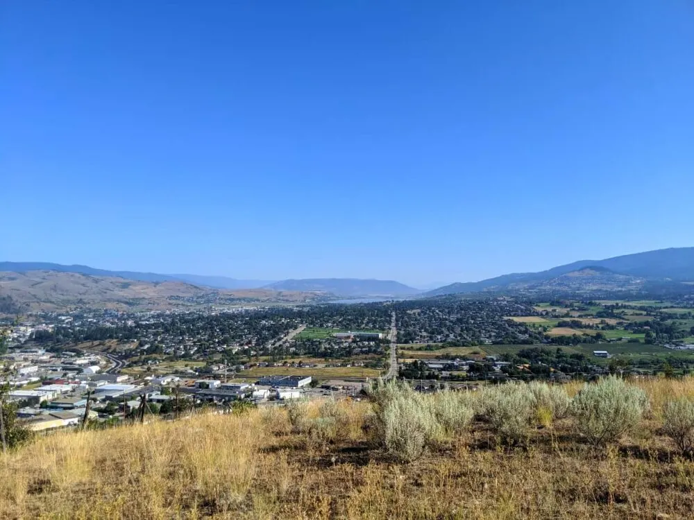 View of Vernon city and suburbs from Middleton Mountain, surrounded by rolling grasslands 