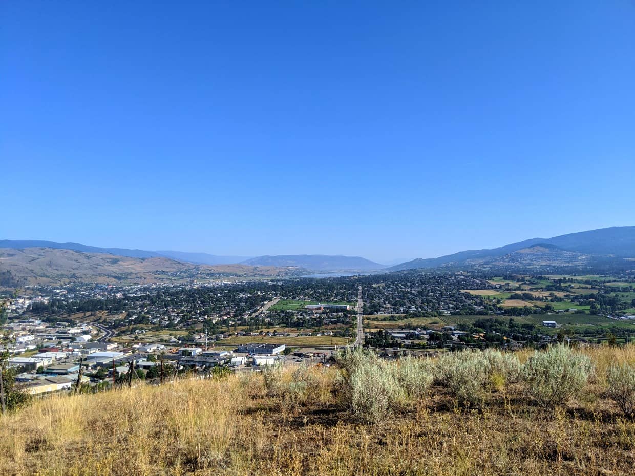 View of Vernon city and suburbs from Middleton Mountain, surrounded by rolling grasslands