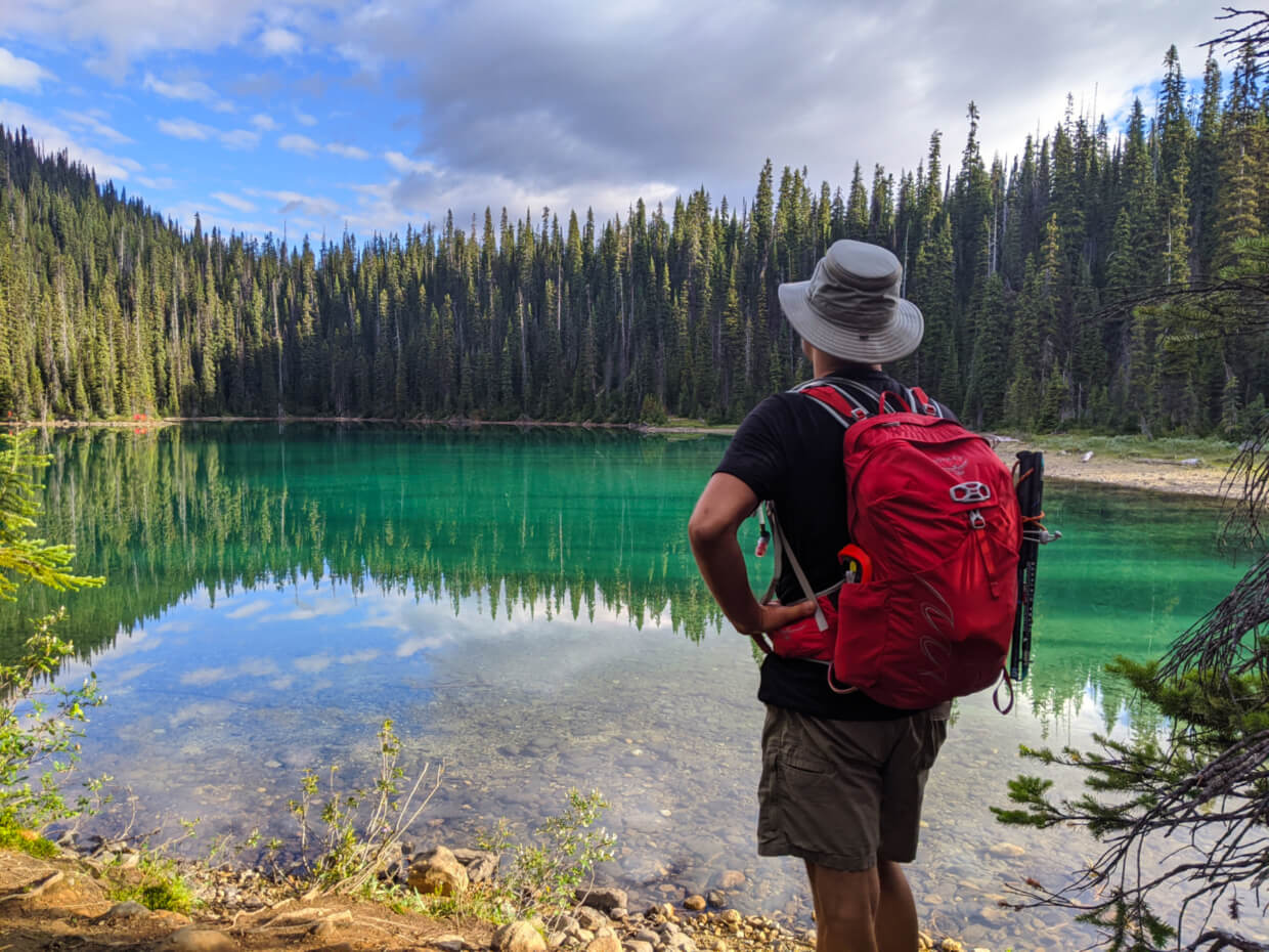 JR standing in front of turquoise Yoho Lake on the way to the Burgess Shale