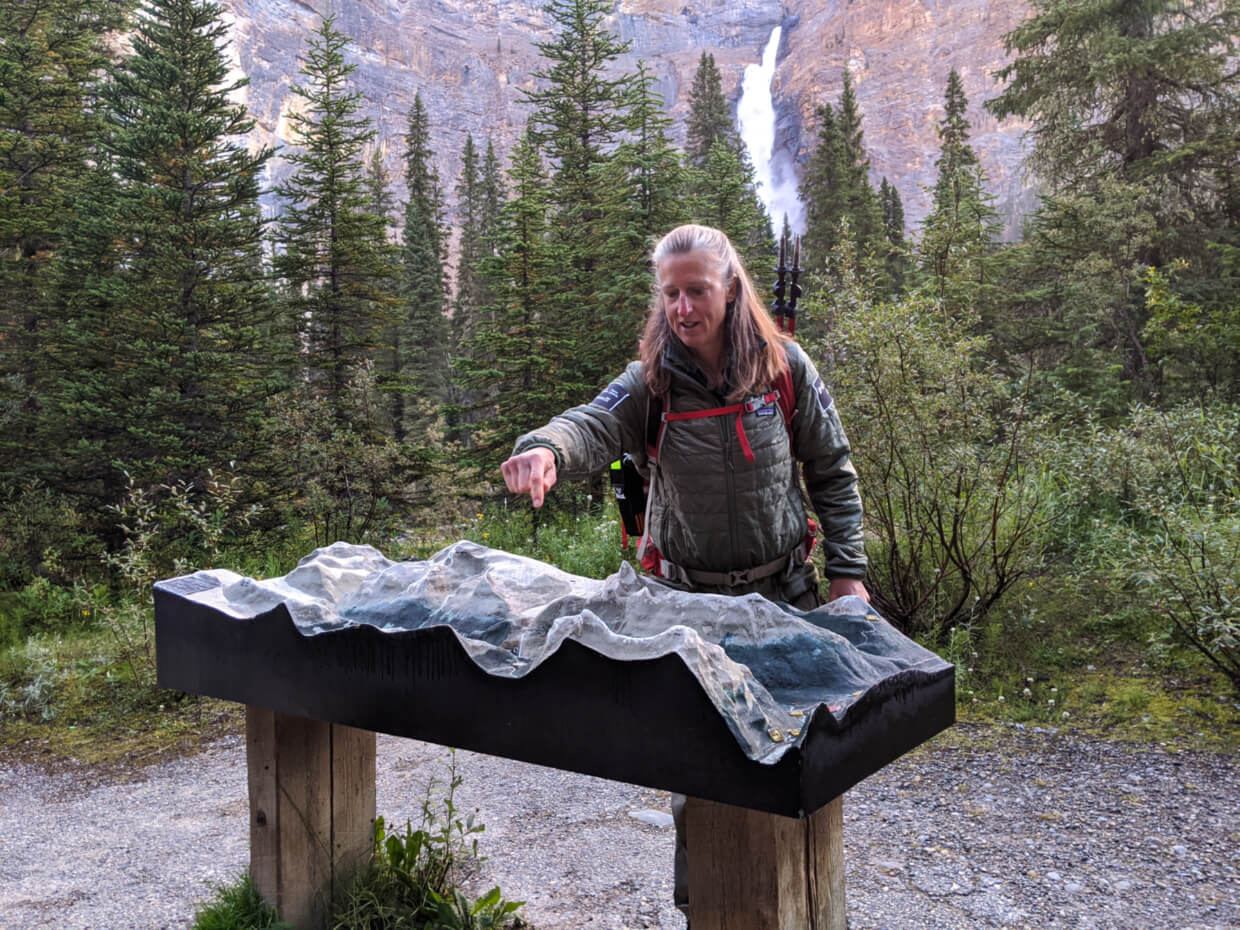 Ardele, our Parks Canada guide, explaining the route of our Walcott Quarry hike using topographic model