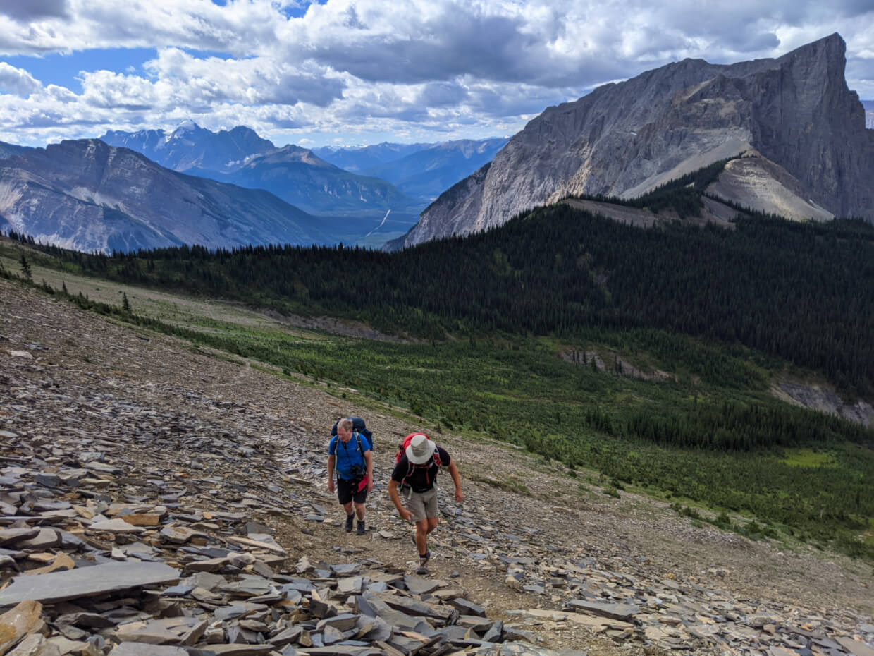 JR and John walk on hiking trail through shale to reach Walcott Quarry