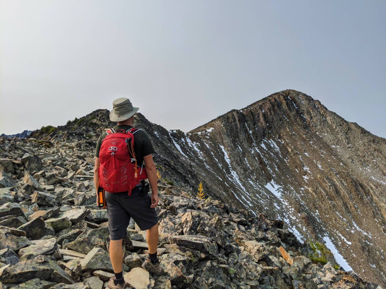 JR on Frosty Mountain ridge looking towards summit, with steep drop-off on right