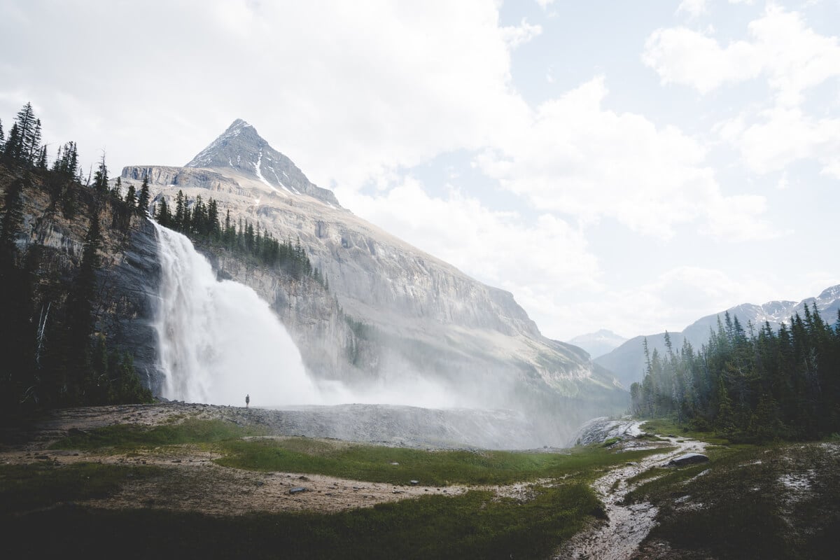 Thundering Emperor Falls on left, with peaked mountain behind. Photo credit Destination BC Brayden Hall