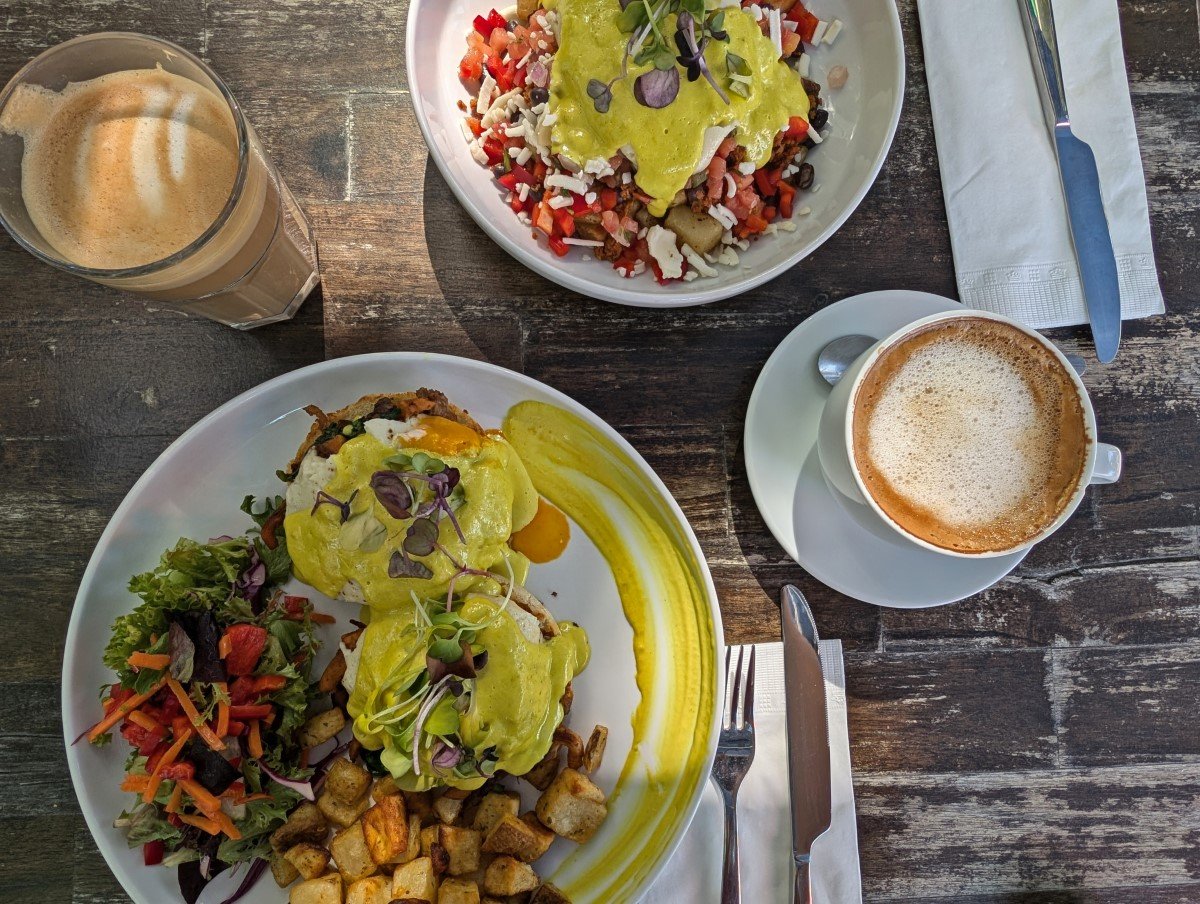 Overhead shot of colourful brunch dishes at StillFood restaurant in Penticton, with coffee