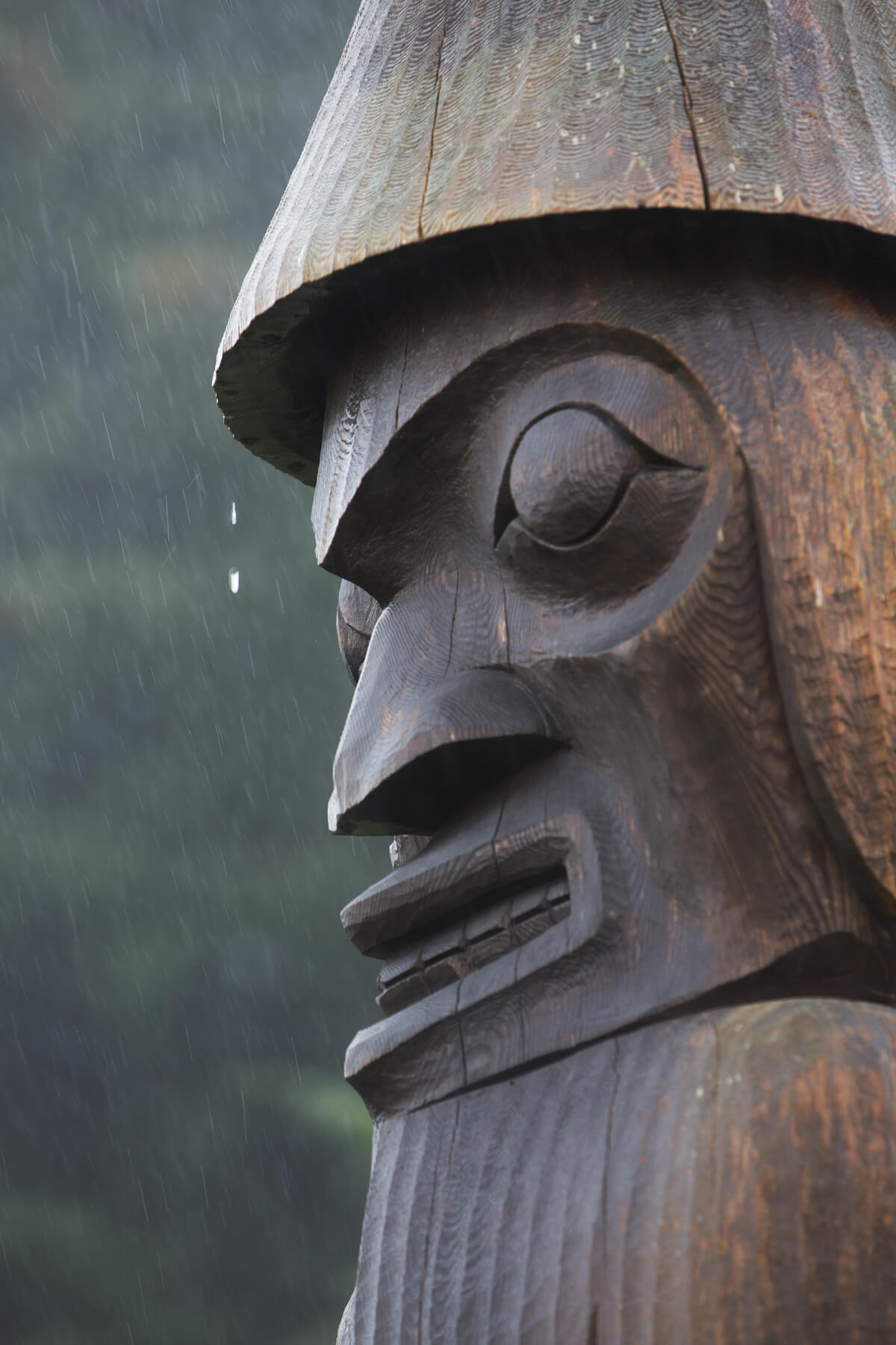 Close up of wooden carved totem pole in Yuquot, at the end/start of te Nootka Trail