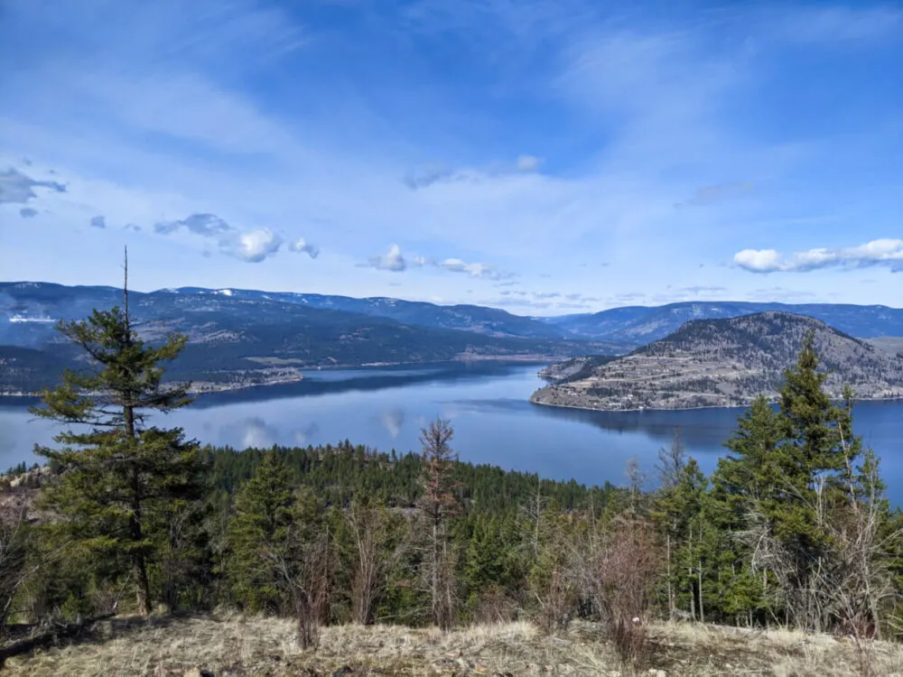 Elevated view looking down on Okanagan Lake from Sparkling Hill Resort, with hilly terrain surrounding water