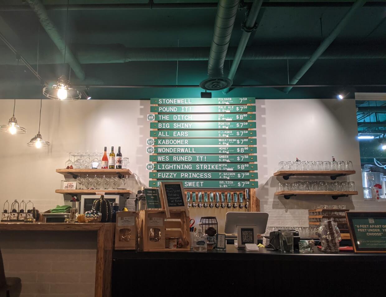 View towards counter at North Basin Brewing Co with list of beers behind